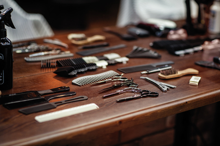 barbershop tools on wooden brown table. Accessories for shaving and haircuts on the table.の写真素材
