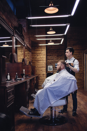 Brown Interior Barbershop with people. Haircut in the men's hair salonの写真素材