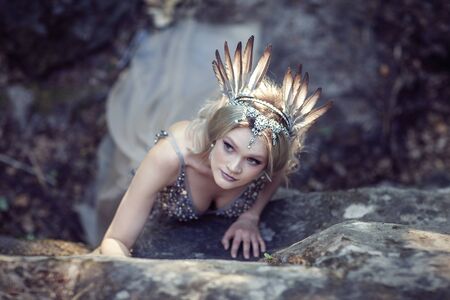 Fairytale girl in beautiful stones. Stones in the moss.の写真素材
