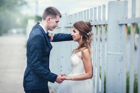 Newlyweds near the iron fence. Linear perspectiveの写真素材
