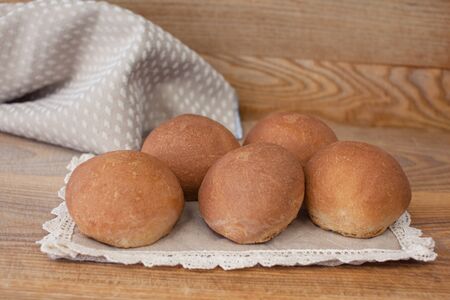 Fresh mouth-watering buns. Several delicious round bunsの写真素材