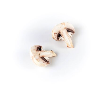 Fresh champignon mushroom cut in two halves on a white backgroundの写真素材