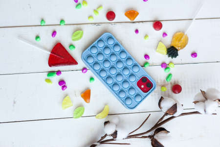 Phone case with pop it on white wooden backgroundの写真素材