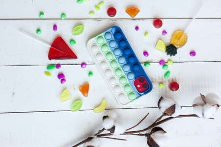 Phone case with pop it on white wooden backgroundの写真素材