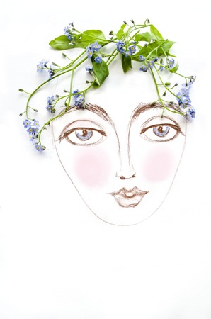 Beautiful woman face with green plant and blue flowers instead of hair, isolated on white...