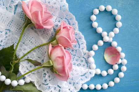 Bouquet of roses and pearl necklace in a figure 8. Women's Day greeting card. 8 March. International Happy Women's Day. The 8th of March banner and poster.の写真素材
