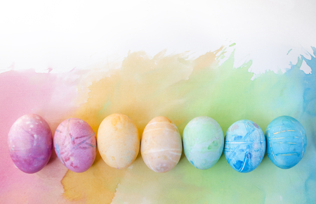 Watercolor background with colorful rainbow Easter eggs.の写真素材