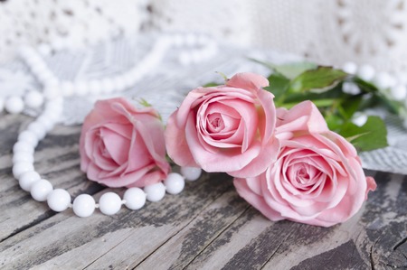 Pink roses bouquet on a wooden background. Mother's Day background. Holiday and seasonal design. Greeting card and copy space.の写真素材