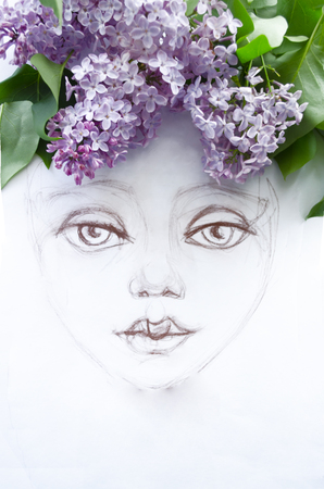 Primed girl portrait on white paper, decorated with natural branches of lilac.の写真素材