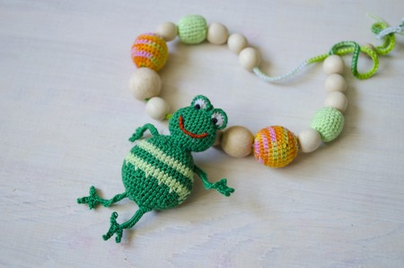 Knitted green handmade crafted frog. Children's toy. Crochet pattern. Handicraft manufacturing.の写真素材