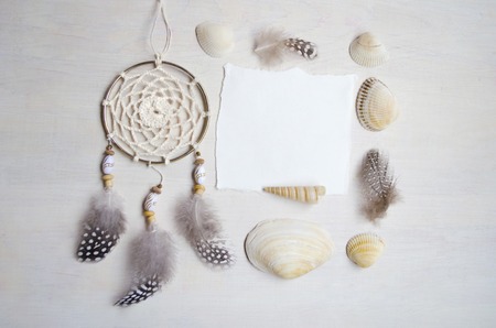 Seashells frame on wooden background with place for text. Card for a beach party, invitation, advertising. Dreamcatcher.の写真素材