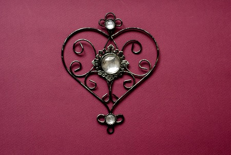 Card with heart shaped pendant for banner design. Card with pendant on red backdrop. Romantic day concept. Valentine heart card design.の写真素材