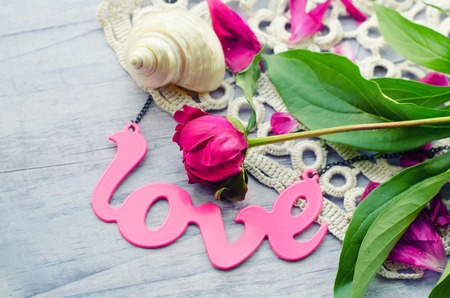 Beautiful fresh peoniesand and some decorations on wooden surface.の写真素材