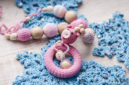 Necklace made from knitted pig and toys for the baby sitting in a sling. Sling necklace.
