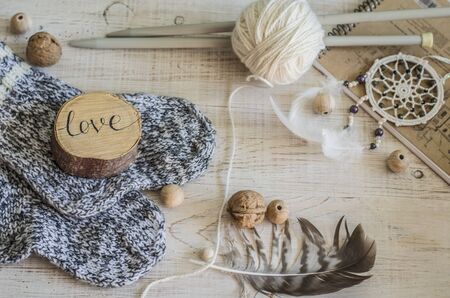 Composition with the inscription Love, wooden and knitted elements. Cozy photo in the style of a hugge.の写真素材