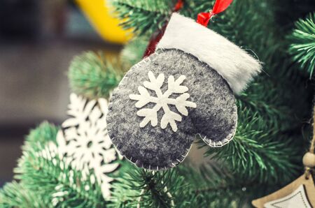 A composition featuring the Merry Christmas and bright winter gloves. A greeting card in a minimalist Scandinavian style.の写真素材