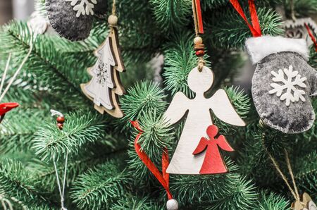 Wooden angel on the background of Christmas tree. Christmas decor. Greeting banner, postcard,の写真素材