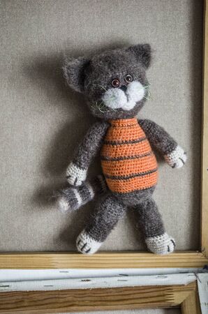 Knitted striped handmade crafted cat. Children's toy. Crochet pattern. Handicraft manufacturing.の写真素材