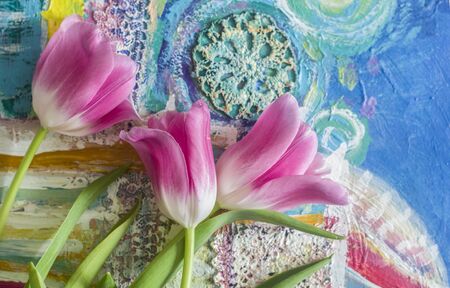 Beautiful composition with rose tulips on patterned background. Spring floral art photo.の写真素材