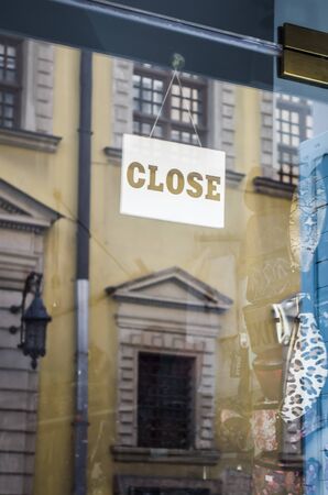The sign CLOSE on the window of the city store. Quarantine closure of small business, concept photo.の写真素材