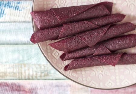 Sweet pure fruit pastille. Natural sweets from dried berries and fruits. Useful sweetness is pastille, fruit chips. Dietary vitamin nutrition. Vegan Food. hand-made sweets, sweetness, dessert.の写真素材
