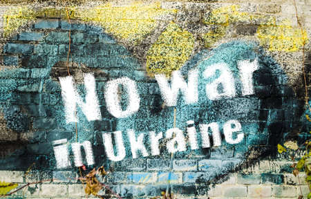 No war in Ukraine poster banner yellow blue. Photo brick wall graffiti heart.の写真素材