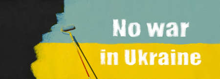 No war in Ukraine poster banner yellow blue. A fragment of the wall is painted with a paint roller. Horizontal photo for banner. Contains space for text.の写真素材