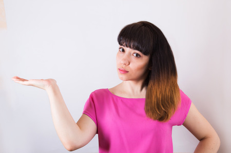 The girl stretched out his hand as if he is holding something on itの写真素材