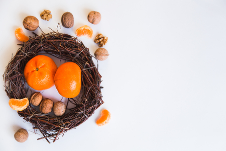 Christmas wreath, mandarins, walnutsの写真素材