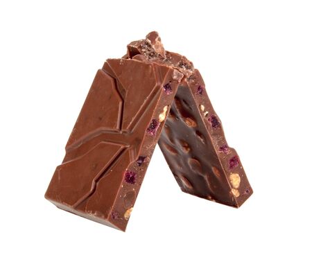 milk chocolate with nuts and berries brocken isolated on the white