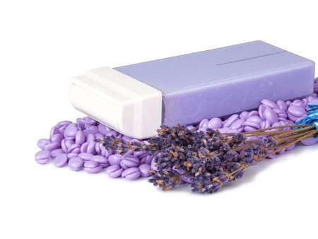 Violet wax drops and lavender for waxing depilation isolated on the whiteの写真素材