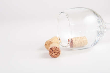Wine cork in wine glass on white backgroundの写真素材
