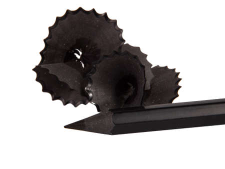 Pencil spiral black sawdust macro isolated on the whiteの写真素材