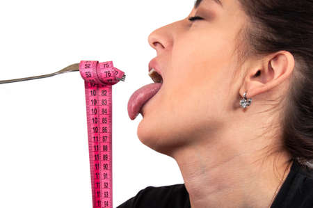 Girl face and tape measure in mouth isolated on the white