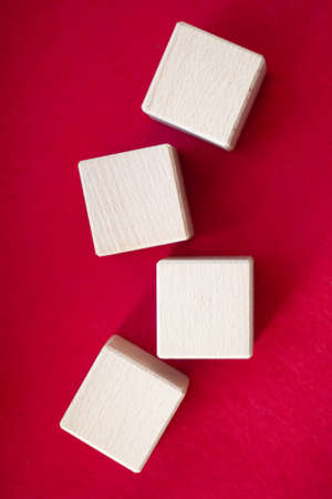 Wooden block on red background with space for textの写真素材