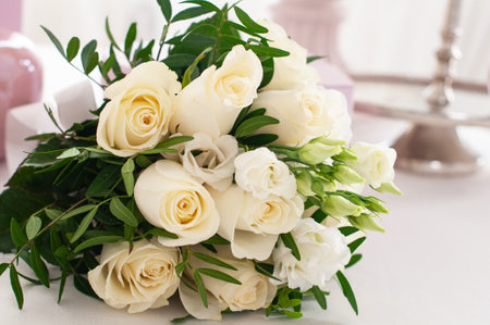 Wedding bouquet of white roses on the white tableの写真素材