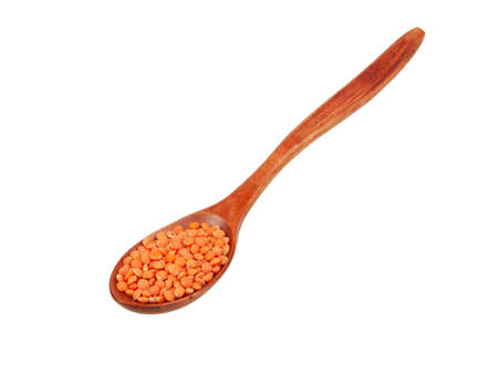 Red lentil in wooden spoon isolated on the white backgroundの写真素材