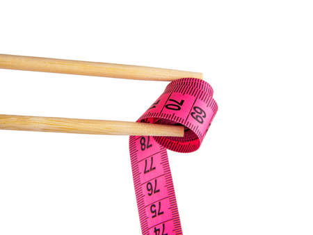 Bamboo sushi sticks with pink tape measure isolated on the white background
