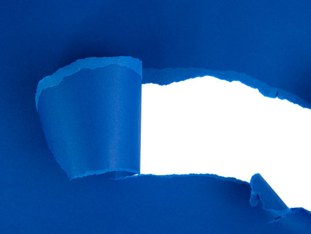 Blue torn sheet of paper with whole space for textの写真素材
