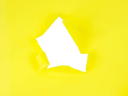 Yellow torn sheet of paper with whole space for textの写真素材