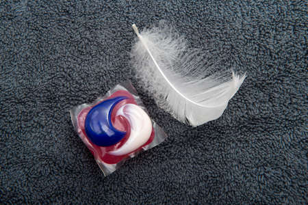 Gel capsule for washing powder on fabric or cloth with a feather