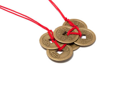three chinese lucky coins with red knot on the whiteの写真素材