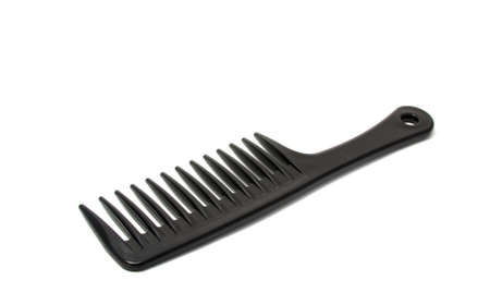Black plastic comb isolated on the whiteの写真素材