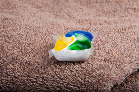 Washing color gel capsule on the brown cloth textureの写真素材