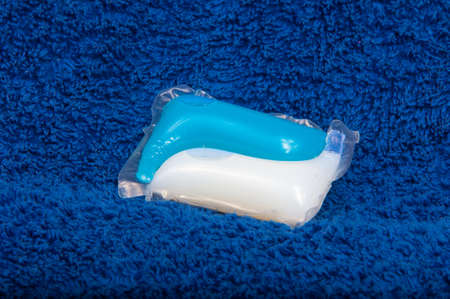Washing color gel capsule on the blue cloth textureの写真素材