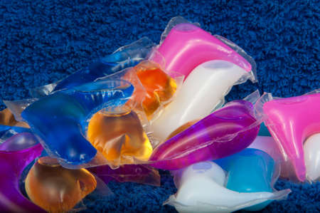 Washing color gel capsule on the blue cloth textureの写真素材