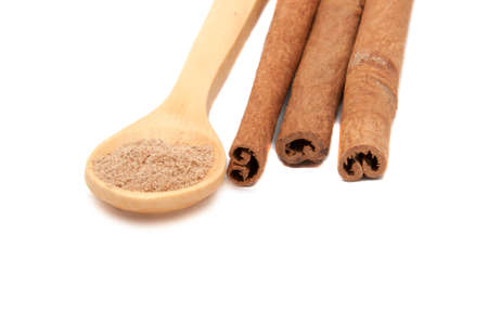 Cinnamon spice sticks with spoon isolated on the whiteの写真素材