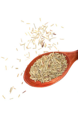 Dried rosemary spice in wooden spoon isolated on the whiteの写真素材