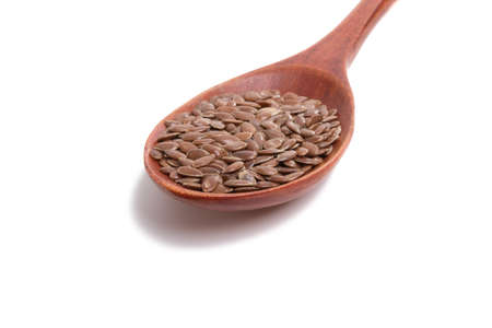 flax seeds in wooden spoon isolated on the whiteの写真素材