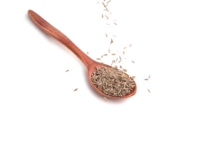 dry zira seeds spice in the spoon isolated on the whiteの写真素材